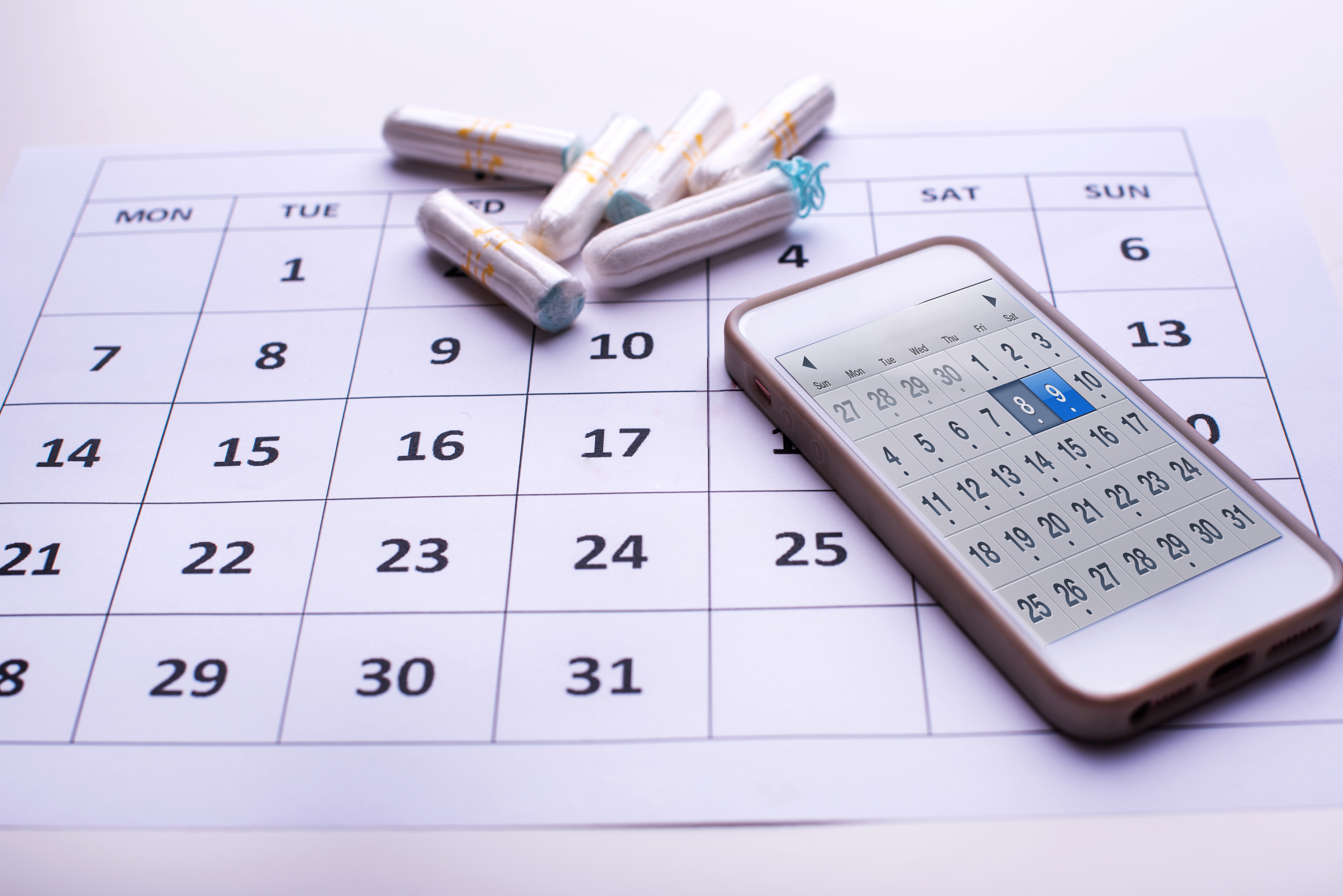 Clean white tampons, mobile phone and Calendar