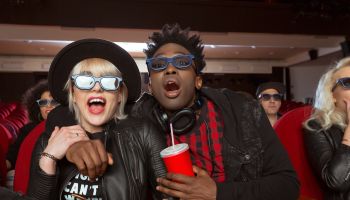 Multi ethnic young couple in 3D movie theater