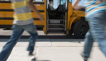 Schoolchildren running to schoolbus