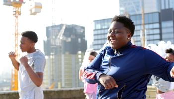 Young street dancers on London rooftop overlooking the city
