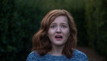 Portrait of shocked young woman looking at camera with negative facial expression