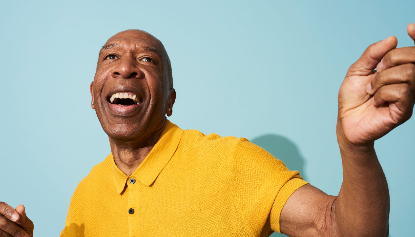 Portrait of a mature man dancing, smiling and having fun