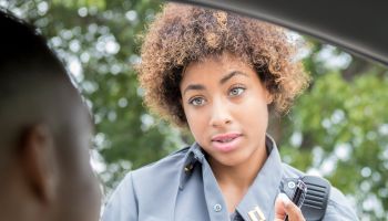 Female police officer reprimands speeding driver