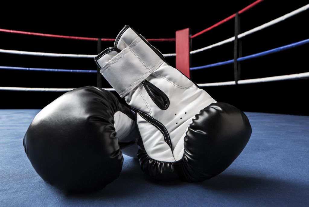 Black boxing gloves inside ring