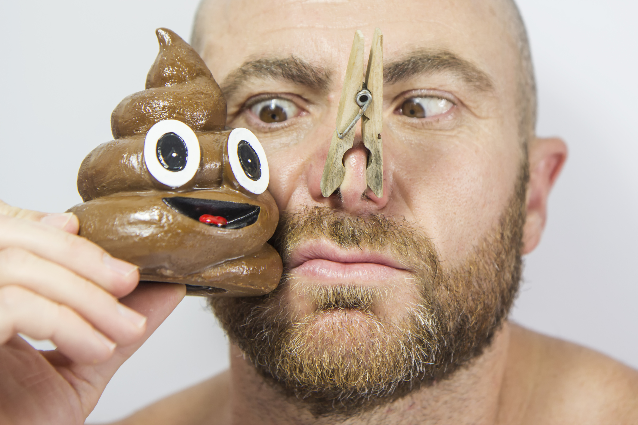 Man with his nose covered to not smell the poop