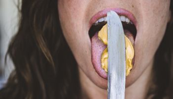 Cropped Image Of Woman Licking Peanut Butter