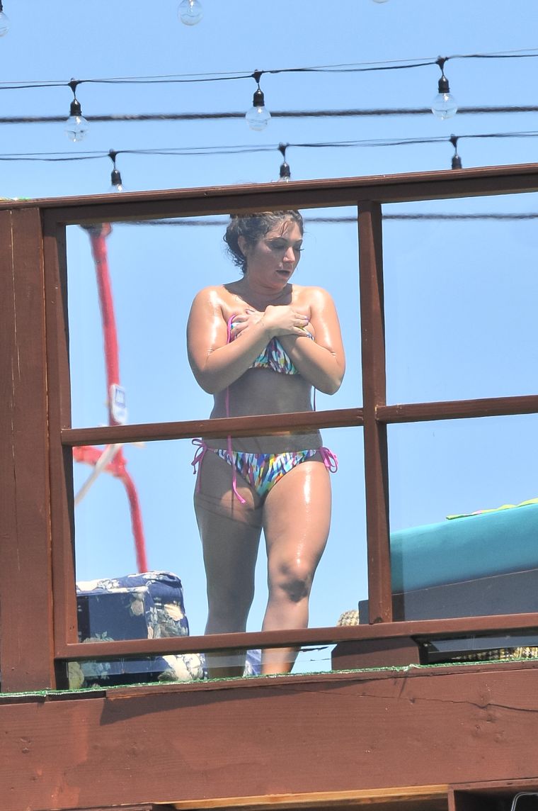 2. Deena Cortese has a wardrobe malfunction at the beach as she and the guys from Jersey Shore escape the heat by taking a dip in the ocean. || Photo Credit: Splash & INF
