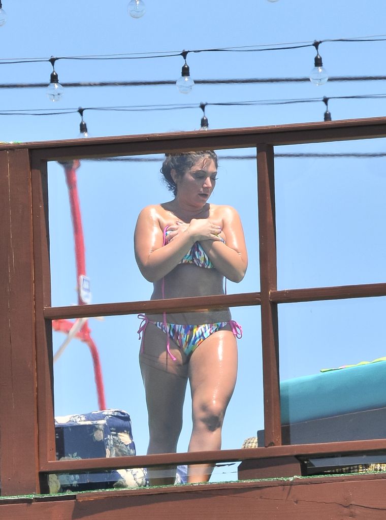 2. Deena Cortese has a wardrobe malfunction at the beach as she and the guys from Jersey Shore escape the heat by taking a dip in the ocean. || Photo Credit: Splash & INF