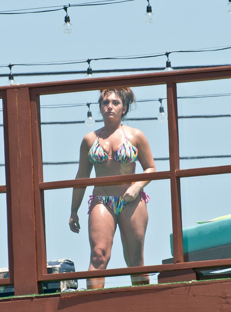 9. Deena Cortese has a wardrobe malfunction at the beach as she and the guys from Jersey Shore escape the heat by taking a dip in the ocean. || Photo Credit: Splash & INF