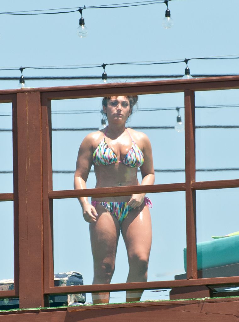 7. Deena Cortese has a wardrobe malfunction at the beach as she and the guys from Jersey Shore escape the heat by taking a dip in the ocean. || Photo Credit: Splash & INF