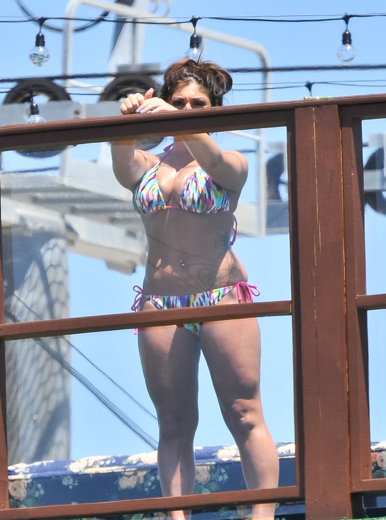 6. Deena Cortese has a wardrobe malfunction at the beach as she and the guys from Jersey Shore escape the heat by taking a dip in the ocean. || Photo Credit: Splash & INF