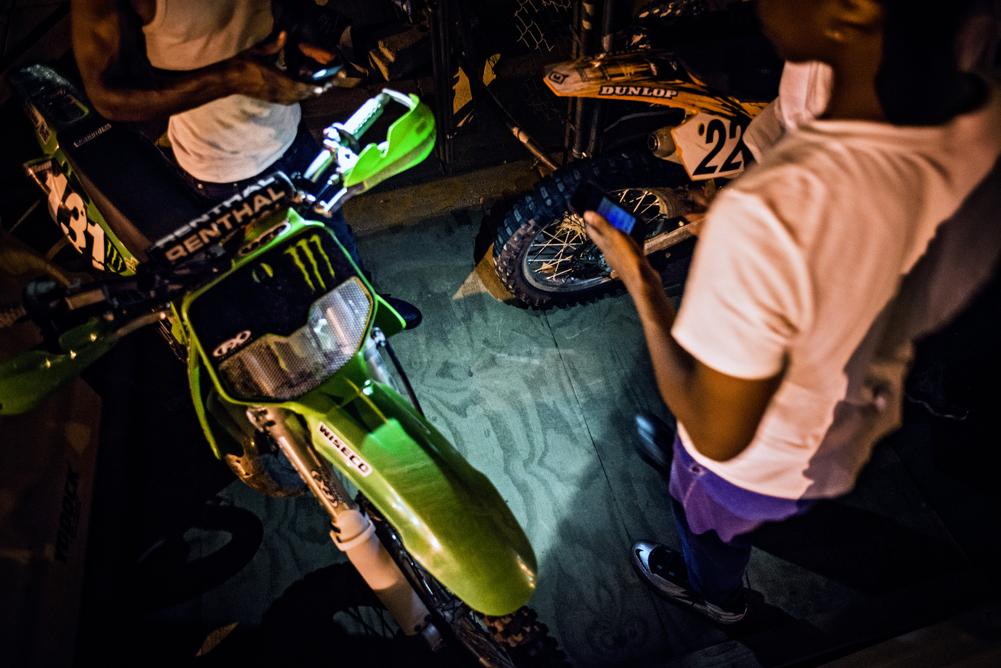 A dirt biker who identified himself as 'Green Man', left, gets ready to ride after refilling his tank behind the offices of NPR on Pierce Street in Washington...