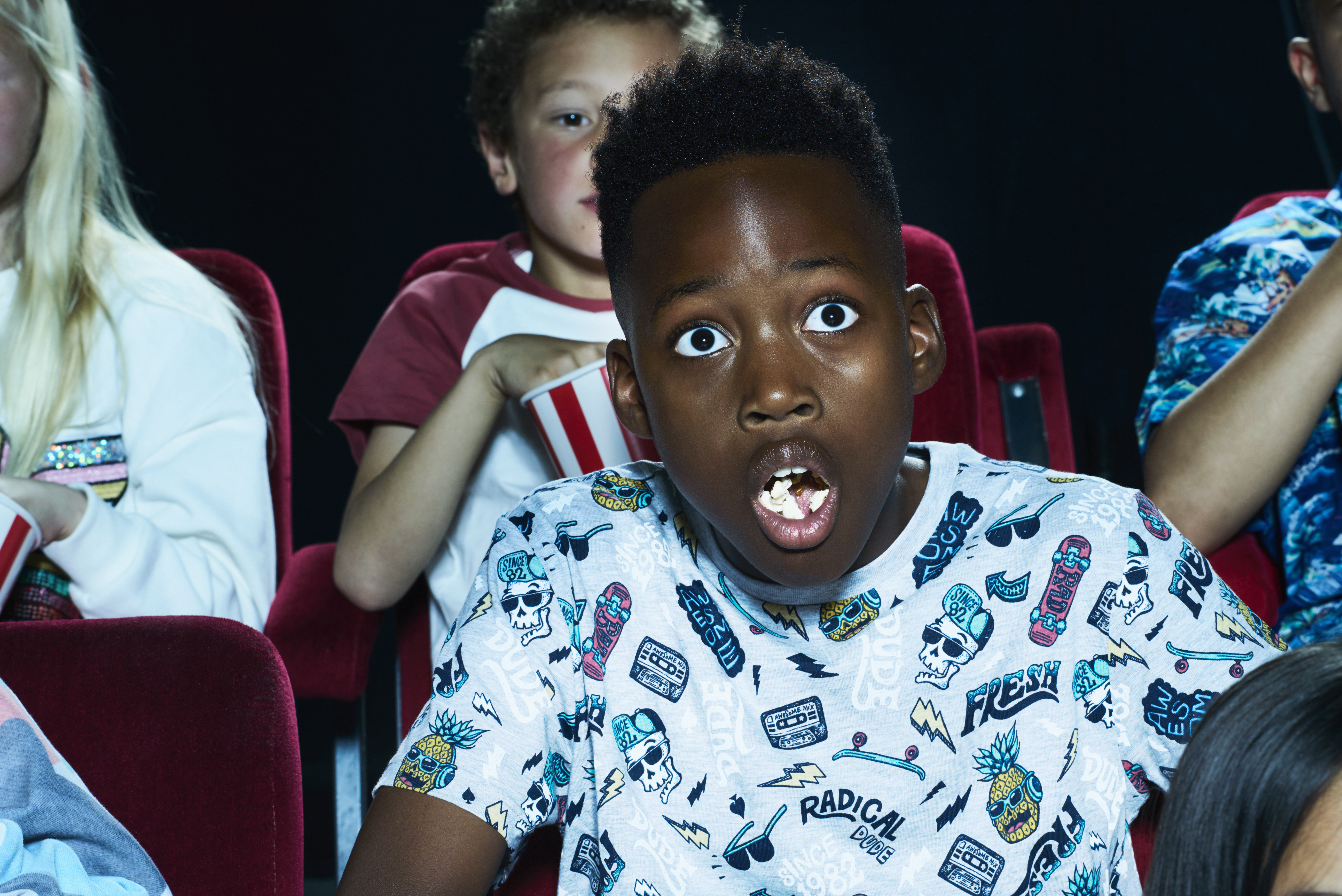 Group of children enjoying a movie at the cinema