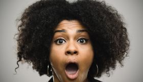 Close-up portrait of a shocked real young afro american woman