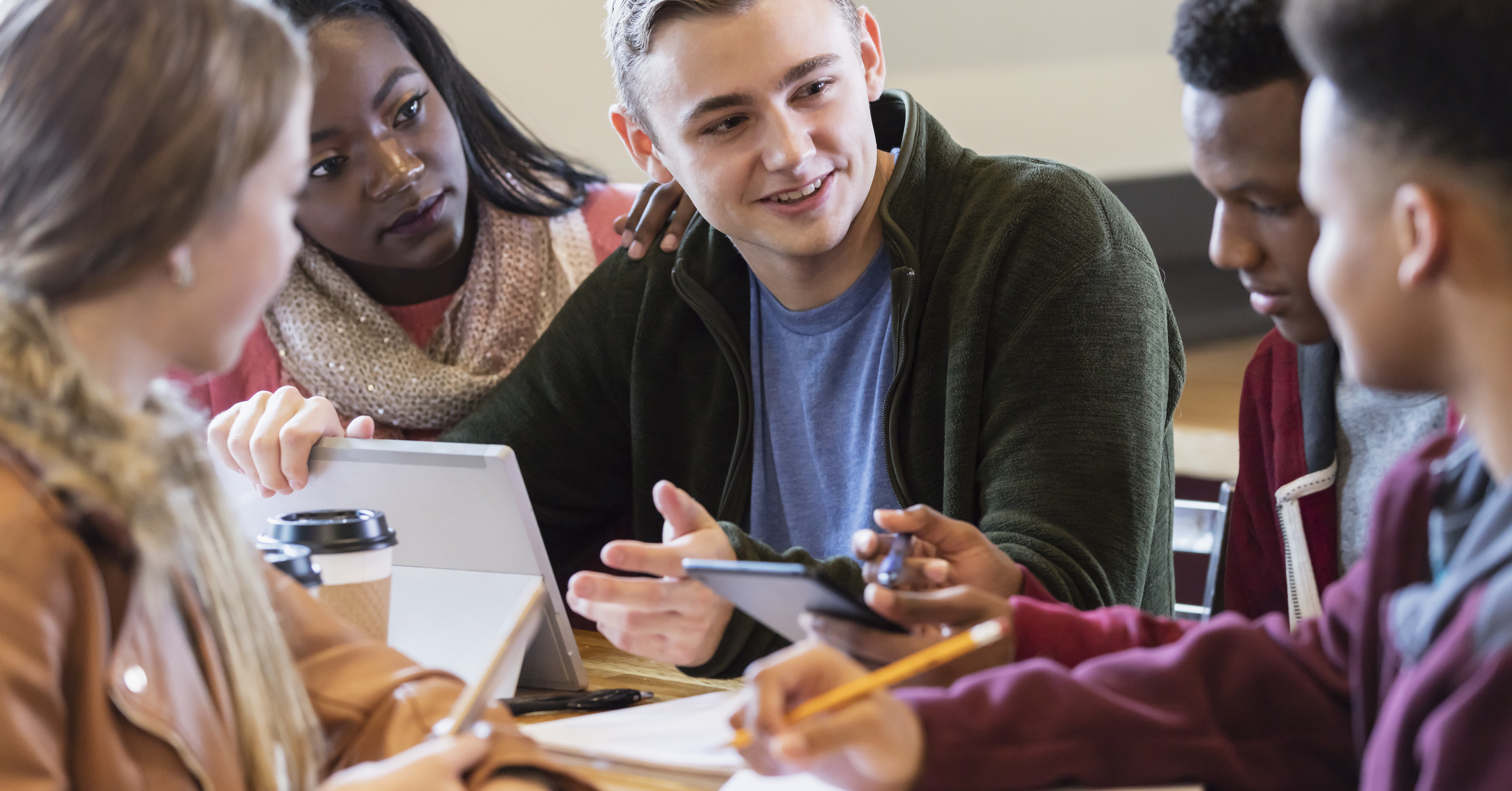 Multi-ethnic teenage friends studying together