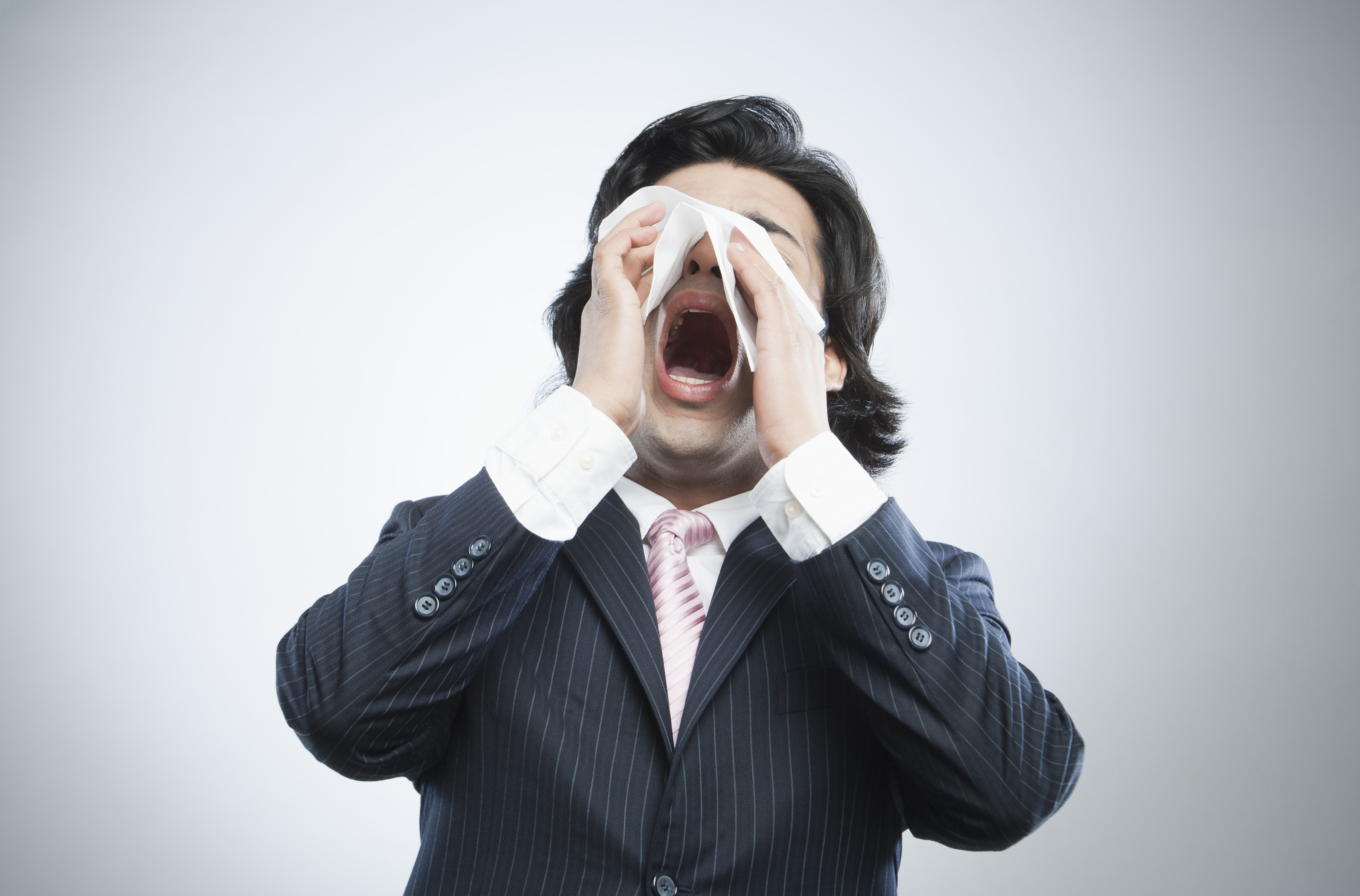 Businessman sneezing
