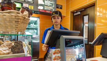 A woman employee at the counter in McDonald's.