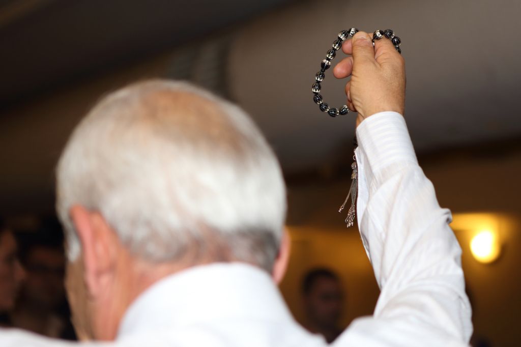 Rear View Of Priest With Worry Beads During Wedding Ceremony