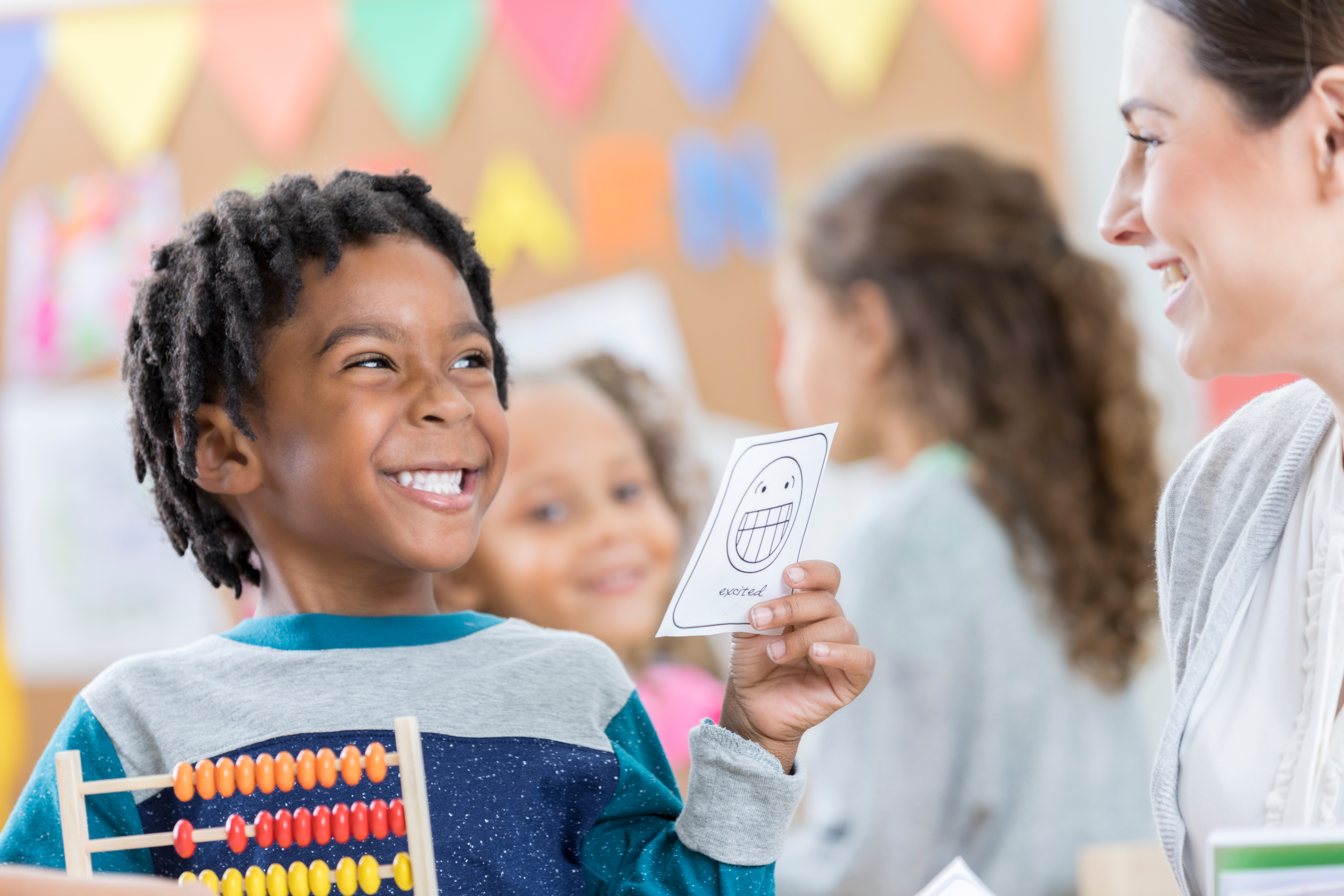 Little boy plays game with after school caregiver