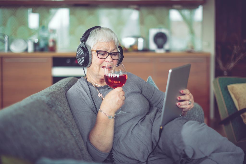Senior woman at home listening music