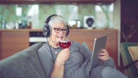 Senior woman at home listening music