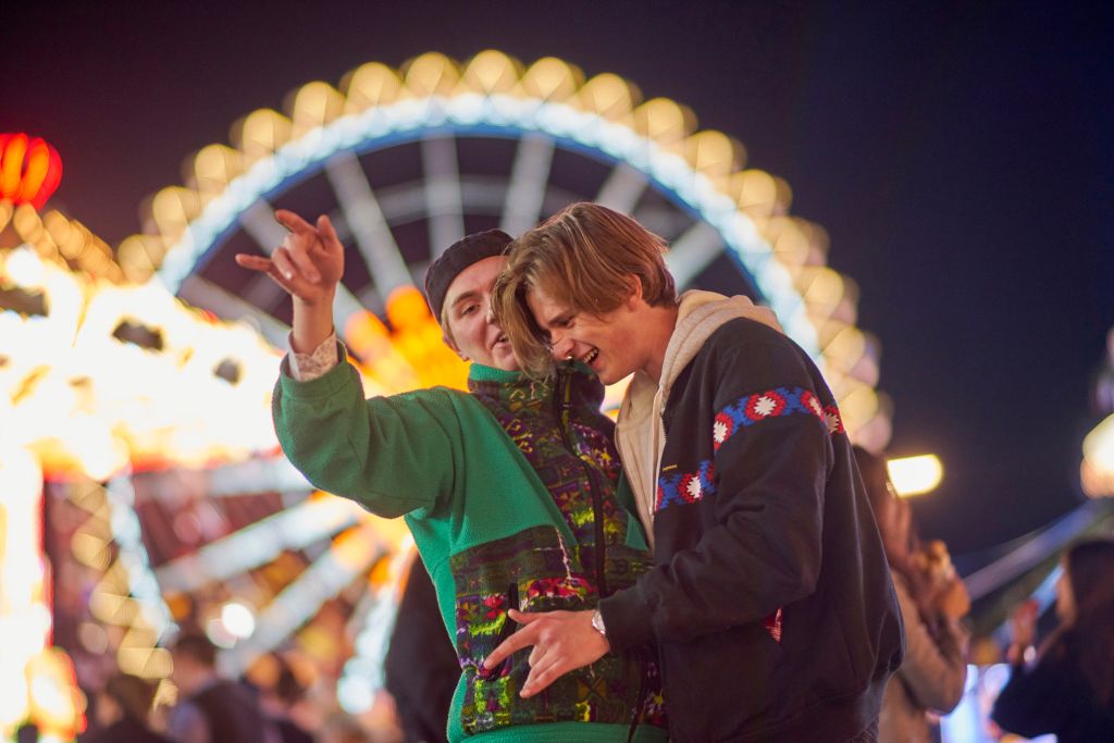 Drunk Men Standing At Amusement Park During Night