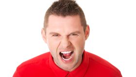 Portrait Of Man Screaming Against White Background