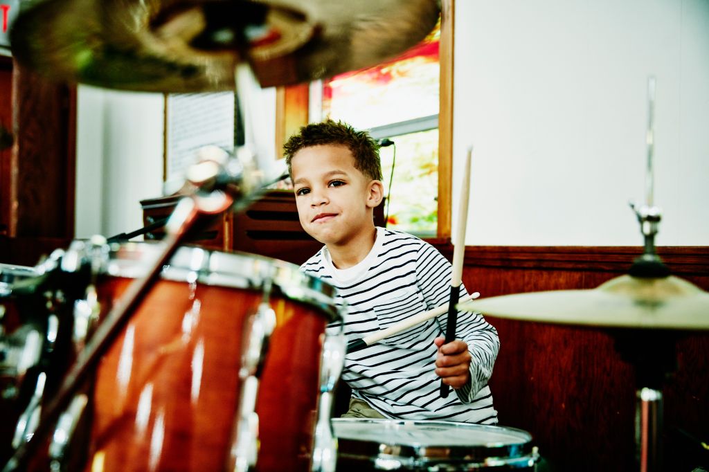 Young boy playing drum set