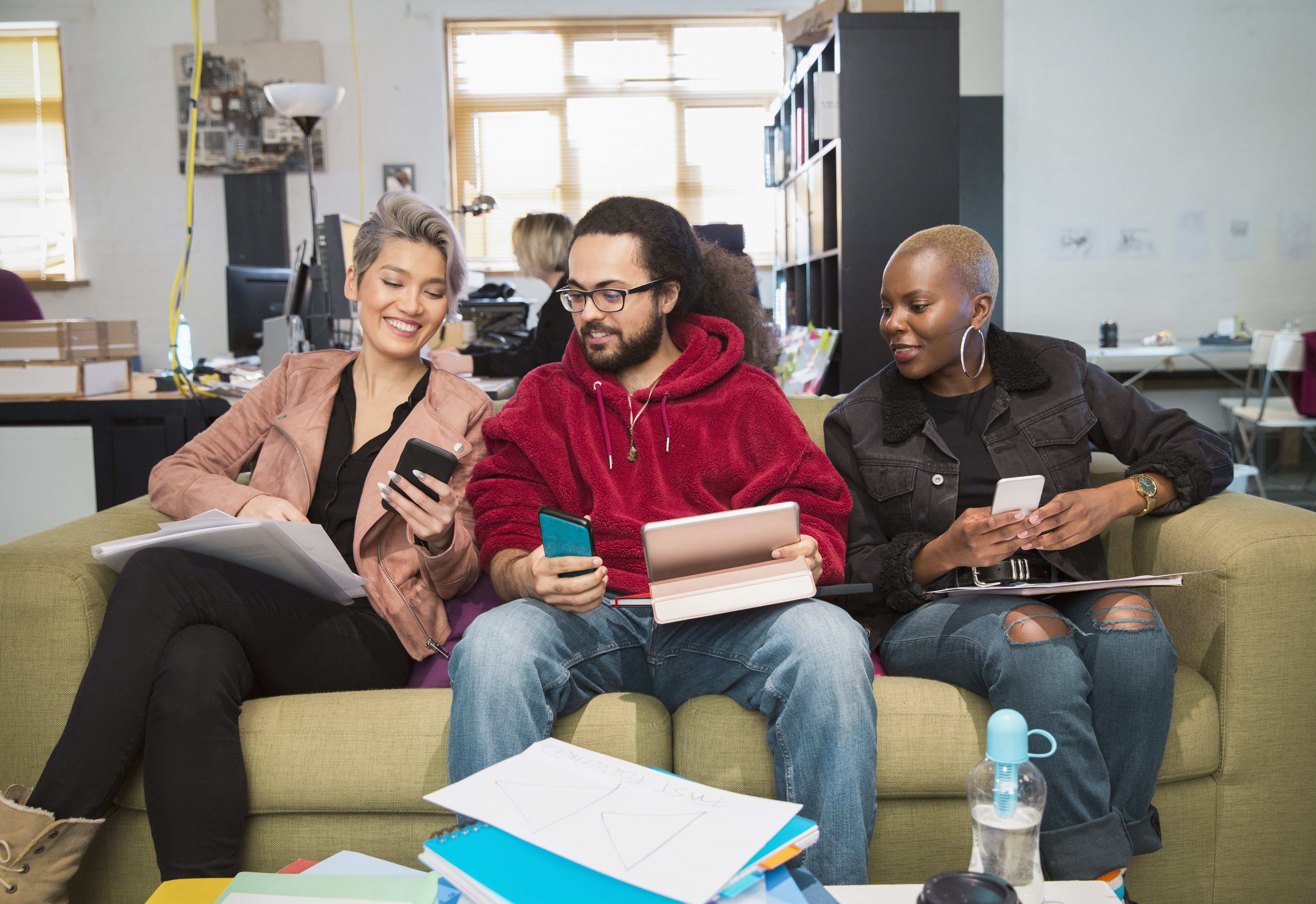 Creative business people using smart phones in office