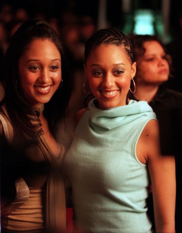 Sister Sister TV stars Tamera, left, and Tia Mowry smile for a herd of media gathered at the foot of