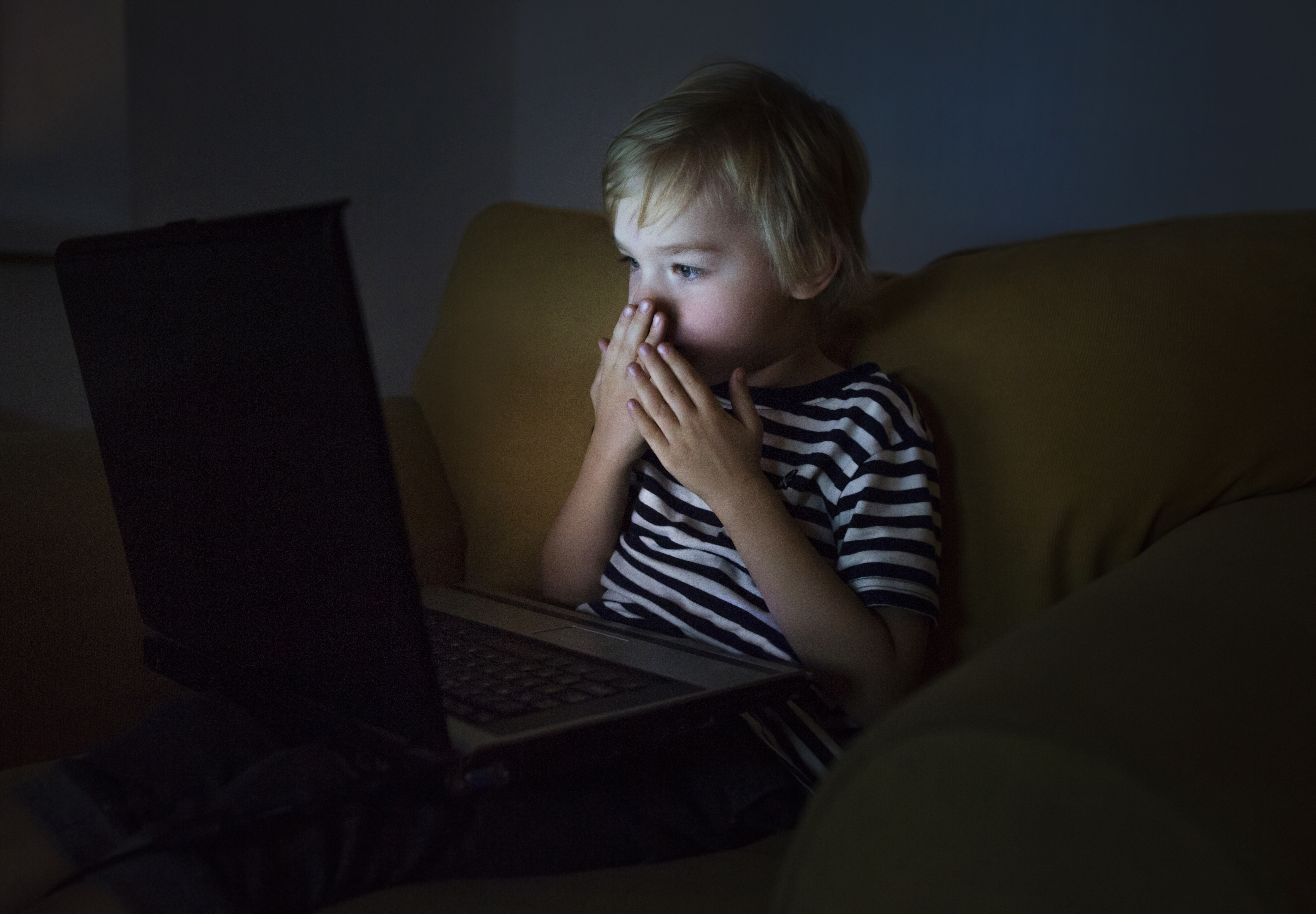 Scared boy in front of the laptop