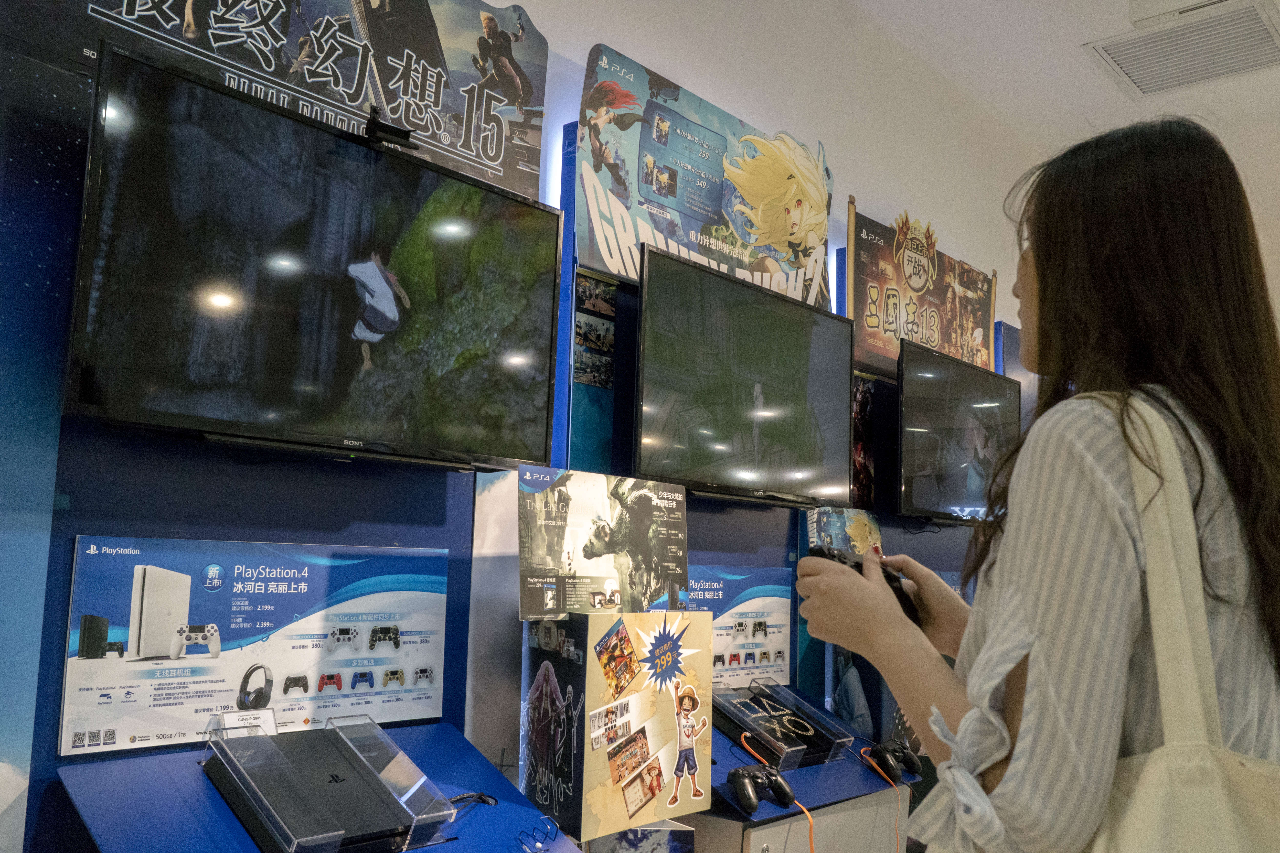 A young girl is experiencing PlayStation 4 in a Sony store...