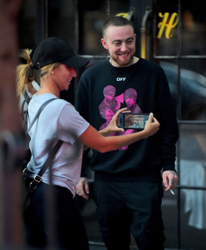 Mac stops to take a photo with a fan.