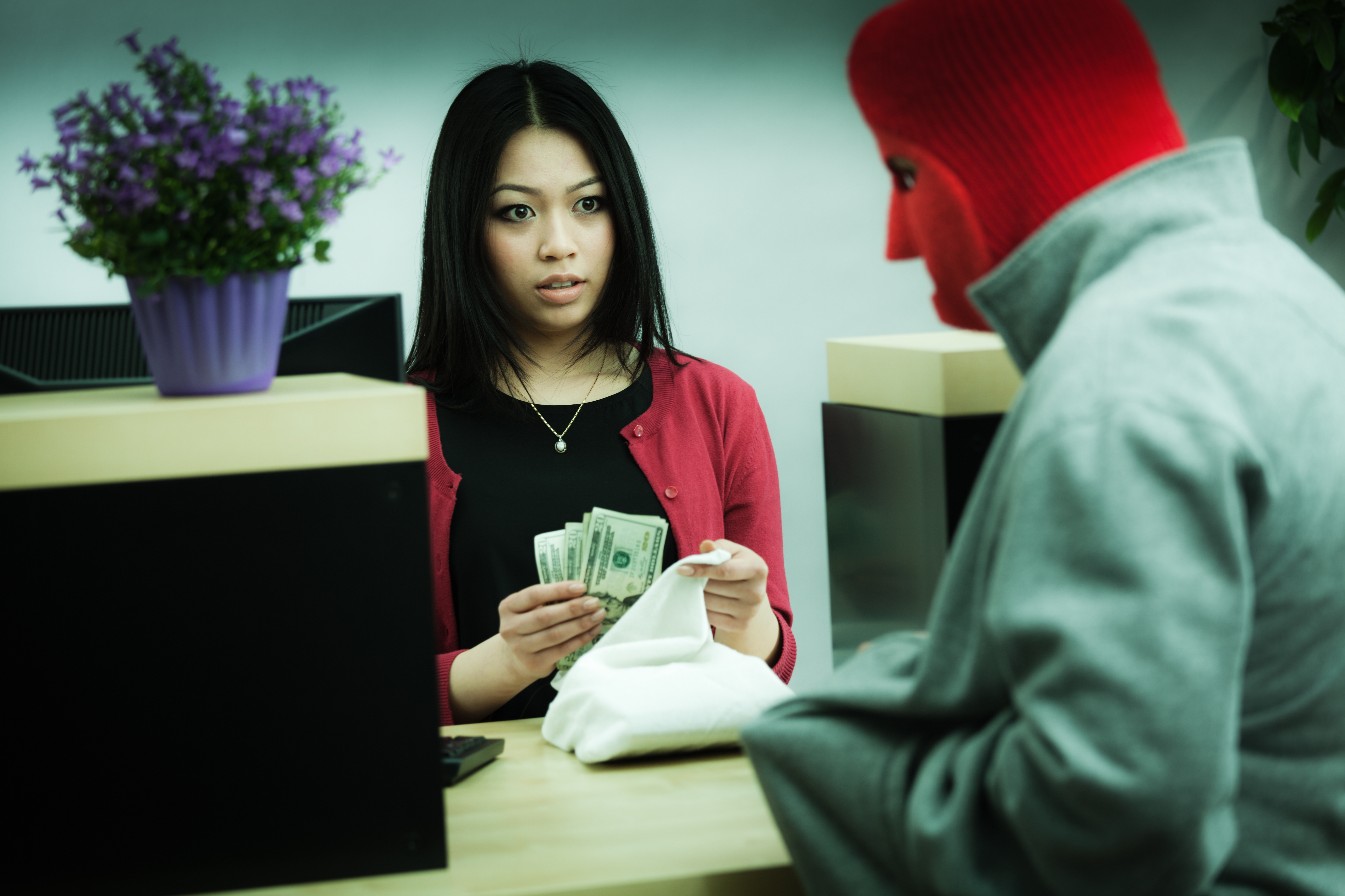 Criminal Robber Robbing an Asian Retail Bank Teller at Counter