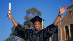 PERBE081 Young man celebrating college graduation,