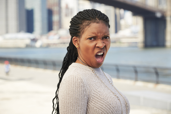 Black woman with disgusted attitude at waterfront