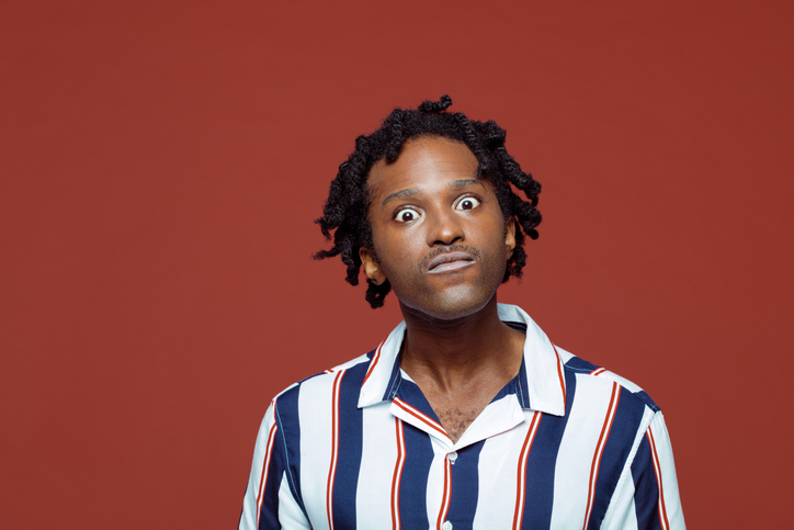 Angry young man in retro style striped shirt