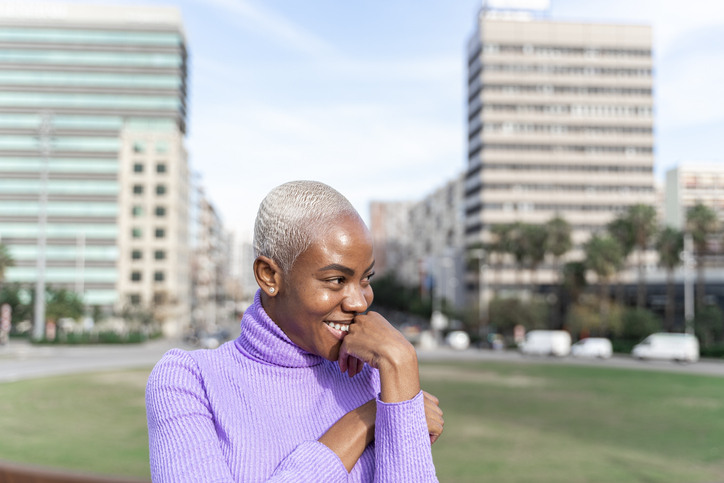 Portrait of smiling white haired woman in the city