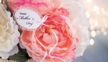 Mother`s Day Greeting Card on a Flower Arrangement