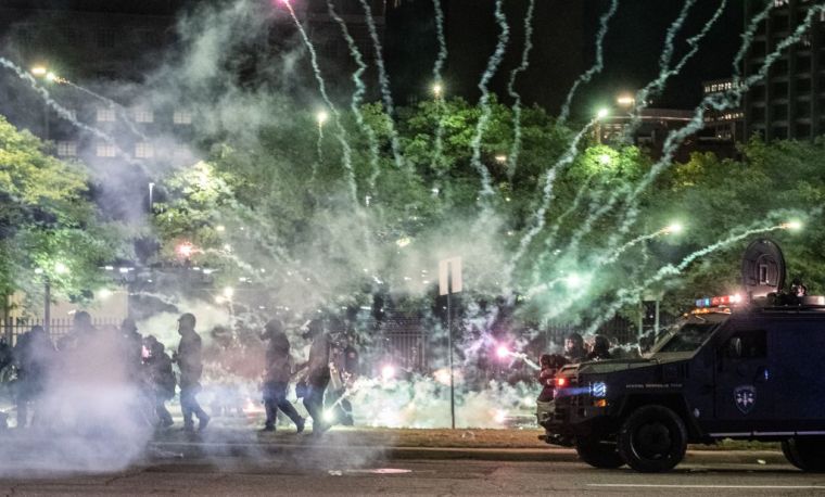Tear gas canisters explode neat some Detroit Police units who attempted to break up protesters.