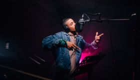 Young hipster African-American rapper recording songs in music recording studio