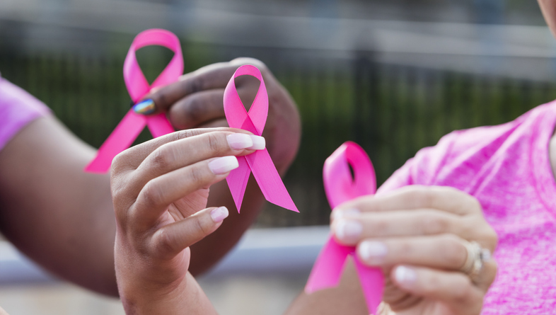 Multi-ethnic women with breast cancer awareness ribbons