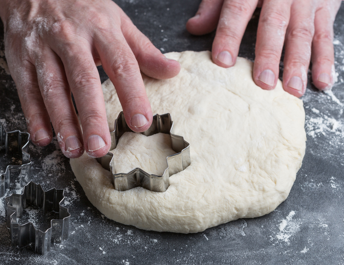The cook uses to roll out dough on a dark background.