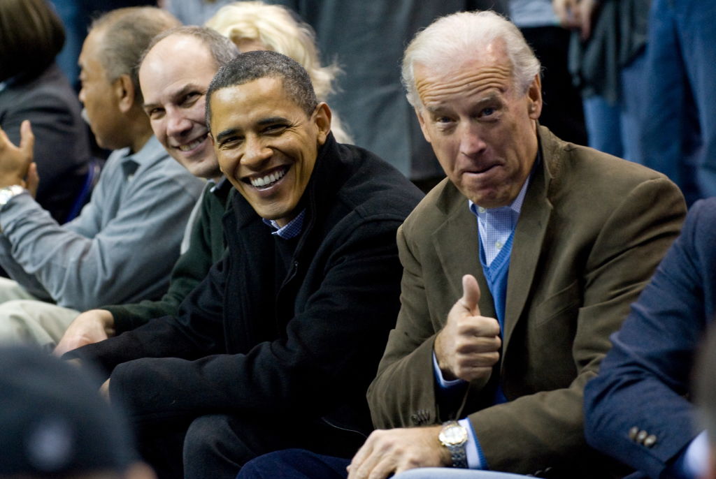 US President Barack Obama sits courtside
