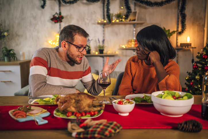 Couple chatting during a home Christmas dinner