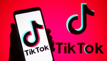 In this photo illustration, TikTok logo is seen displayed on...