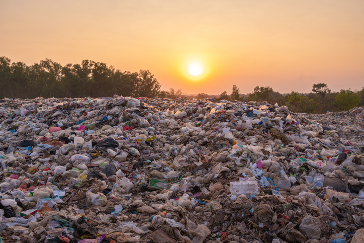 global warming, large garbage pile near the sunset.