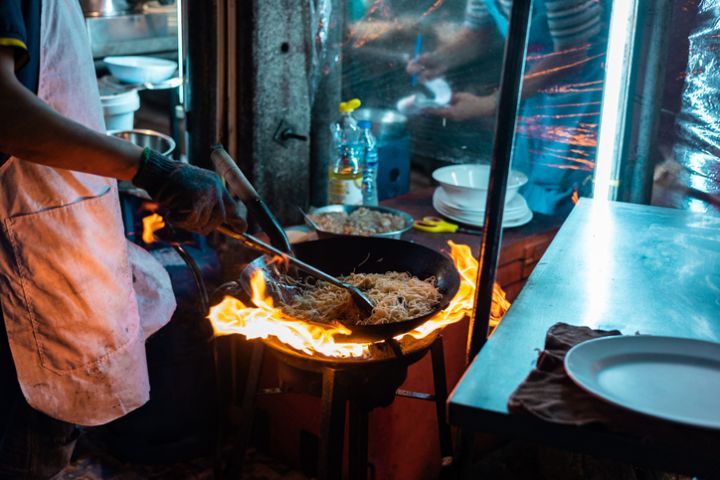 Frying Pan in Burning Flames during cooking in Chinatown Yaowarat,Bangkok ,Thailand.