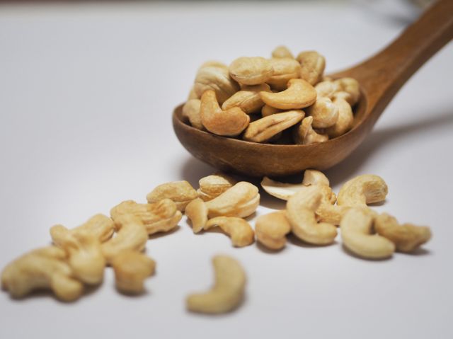 cashew Nuts dried bean in wooden spoon on white background