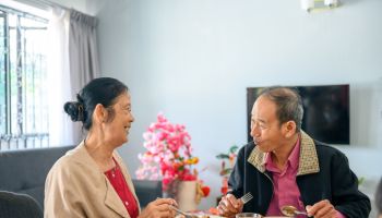 Asian senior couple celebrating chinese new year's eve reunion dinner